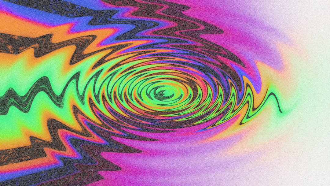 Colorful concentric ripples create a psychedelic effect.