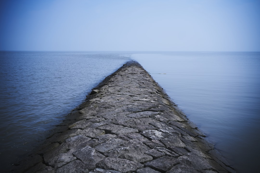 A stone wall in the middle of a body of water